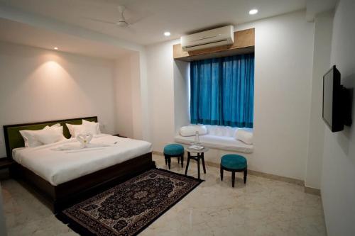 a hotel room with a bed and a window at 1st Luxury in Rāmdevra