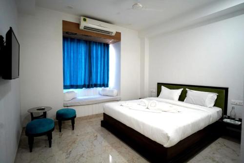 a bedroom with a large white bed and a window at 1st Luxury in Rāmdevra