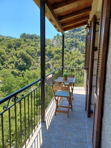 a balcony with a table and a view of the mountains at Rodanthe's Guest House in Stemnitsa