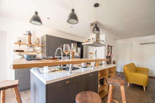 a kitchen with a counter and some chairs in it at Villa Anastasia in Zilia