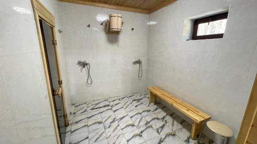 a bathroom with a shower and a bench in it at Orman Ski in Shchuchinskiy