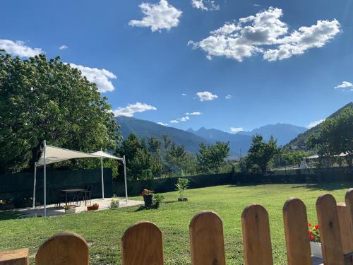 a fence in front of a field with a tent at Ca di Nadia in Aosta