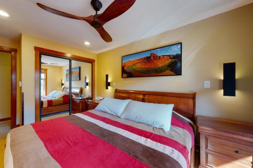 a bedroom with a bed and a ceiling fan at Powderhorn Lodge 408: Rustic Mountain Suite in Solitude