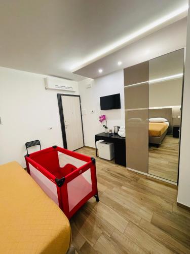 a bedroom with a red bed and a mirror at Affittacamere Residenza Montedoro in Norcia