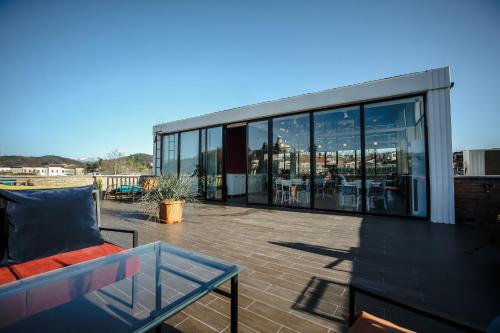 a balcony with a couch and tables on a building at Hotel Rero in Kutaisi