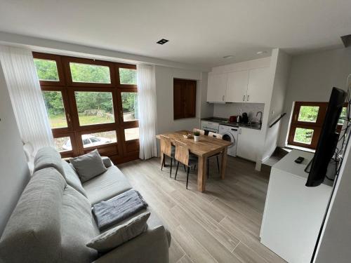 a living room and kitchen with a couch and a table at Palacio de Cambre in Soto de Cangas