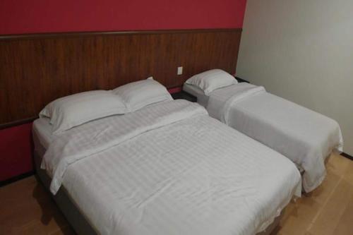 Ένα ή περισσότερα κρεβάτια σε δωμάτιο στο Super OYO 90579 U Inn