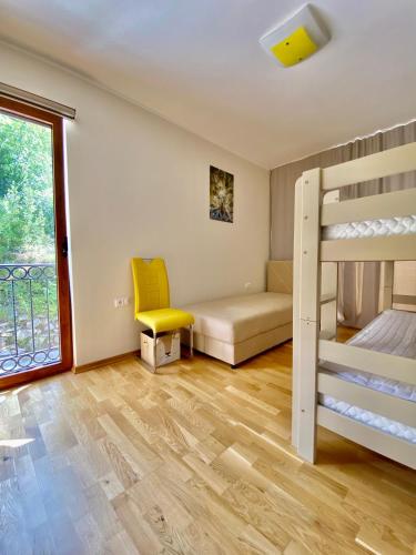 a bedroom with a bunk bed and a couch at Adria Sea & Mountains in Herceg-Novi