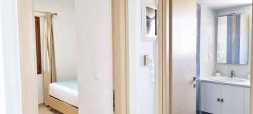 a small bathroom with a sink and a mirror at Simon Sea View in Sitia