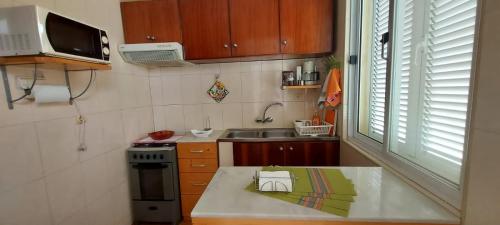 a small kitchen with a sink and a stove at Apt. Idilfa in Praia