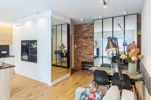 a living room with a brick wall at VIP Apart Bielany przy metrze in Warsaw