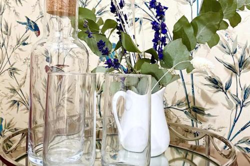 a group of glass vases sitting on a table at Exclusive Georgian apartment in centre of Bath in Bath