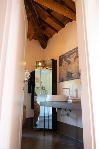a bathroom with a sink and a mirror at Cathedral-luxury-stay sauna & massage in Pescia
