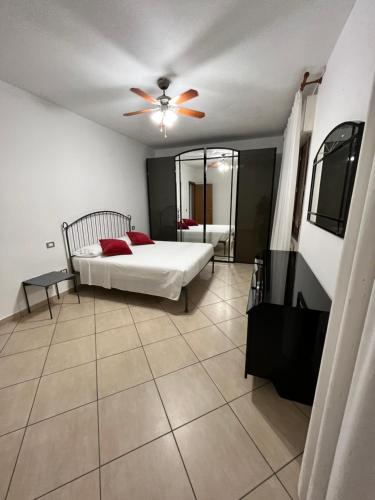 a bedroom with a bed and a ceiling fan at Marzan 12 in Peschiera del Garda