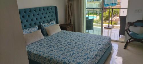 a bedroom with a large bed with a blue bedspread at Bouznika DREAMS in Bouznika