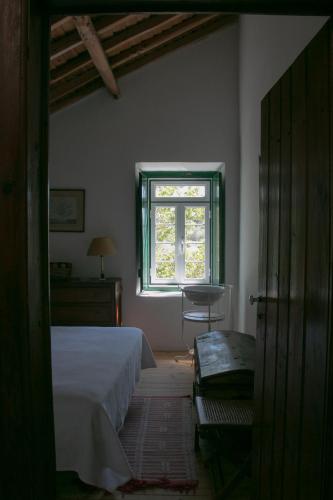 a bedroom with a bed and a window at Quinta de SantAna da Várzea in Abrantes