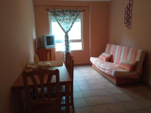 a living room with a couch and a table at Hotel Espadan in Azuébar