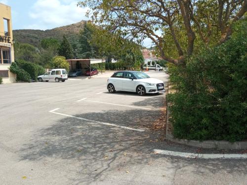a white car parked in a parking lot at Hotel Espadan in Azuébar