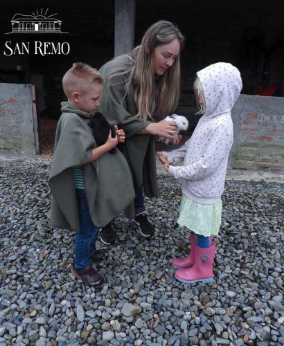 a woman and two children standing on rocks at Hotel Rural SAN REMO in Santa Rosa de Cabal