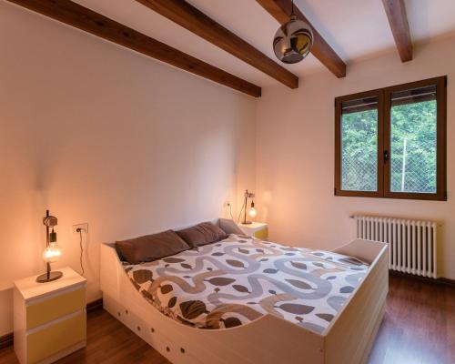 a bedroom with a large bed and two windows at Maison Mialon: country house amidst of nature in La Esperanza