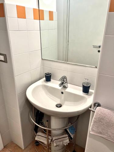 a bathroom with a sink and a mirror at Cá d la trifola free parking in Alba