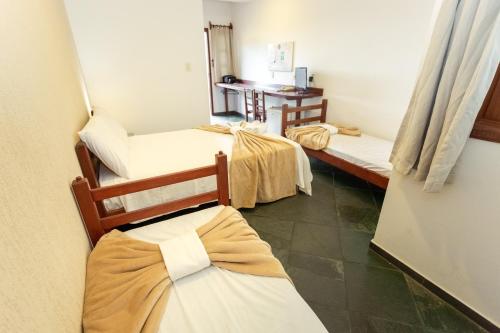 Tempat tidur dalam kamar di Pousada Céu de Estrelas