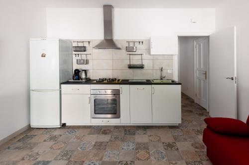 a kitchen with white appliances and a tile floor at Mialon rural apartment: haven of calm in nature in La Esperanza