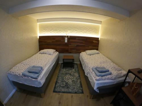 two beds in a small room with at Mono House in Rusnė