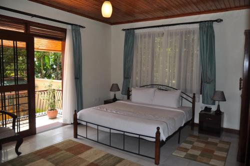 מיטה או מיטות בחדר ב-The Milimani Lodge