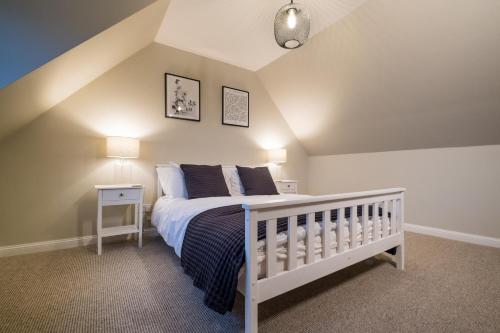 a bedroom with a white crib in a attic at No.70 in Bayble