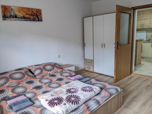a bedroom with a bed and a sliding door at Apartmani Drinska in Foča