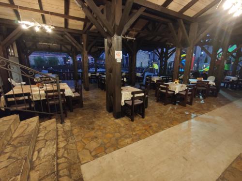 a restaurant with tables and chairs in a building at Ethno Village St George in Cetinje