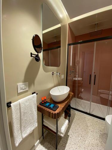 a bathroom with a sink and a toilet and a shower at NoOne Tropea Guesthouse in Tropea