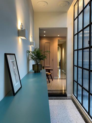 a hallway with a blue counter with a plant on it at NoOne Tropea Guesthouse in Tropea