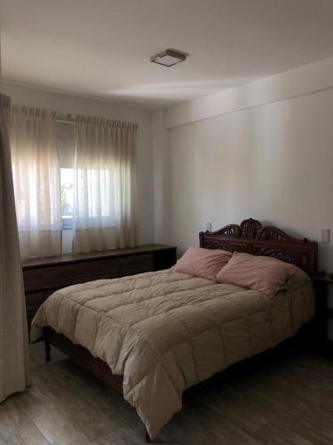 a bedroom with a large bed and a window at Monoambiente Guemes in Salta