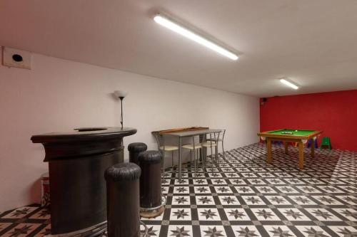 a room with a ping pong table and a ping pong table at CABANA & La Villa sur la Colline - Au Calme in Saint-Symphorien-des-Bois