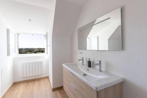 a white bathroom with a sink and a mirror at CABANA & La Villa sur la Colline - Au Calme 