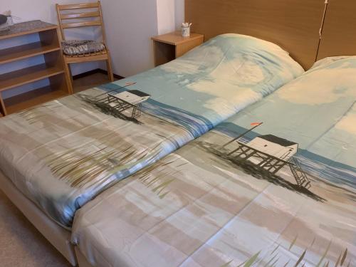 a bed with two chairs sitting on top of it at B&B Molenaar in Buren
