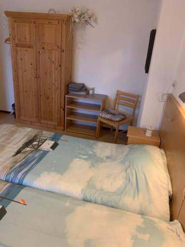 a bed in a room with a desk and a chair at B&B Molenaar in Buren