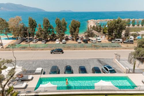 a view of a parking lot with a swimming pool at Mazarine Hotel, Vlorë, Albania in Vlorë