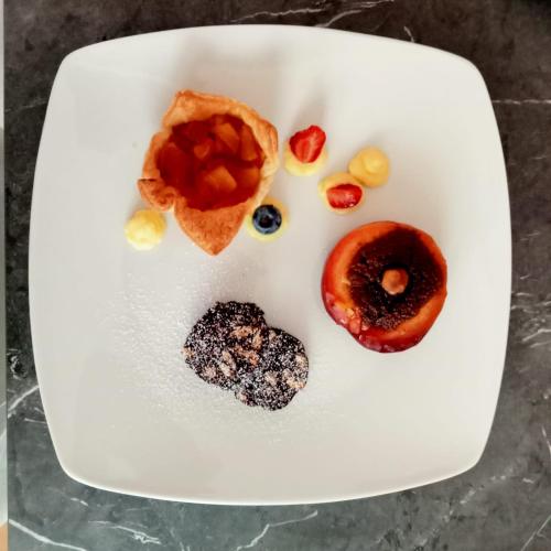 a white plate with different types of donuts on it at SANTINO'S HOUSE in Peveragno