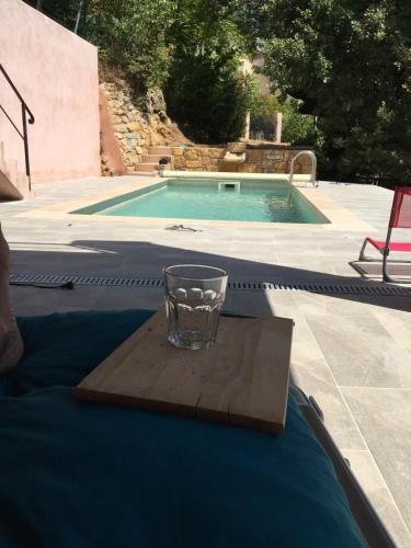 - un verre sur une table à côté de la piscine dans l'établissement à l'ombre du gros chêne, à Sainte-Anastasie-sur-Issole