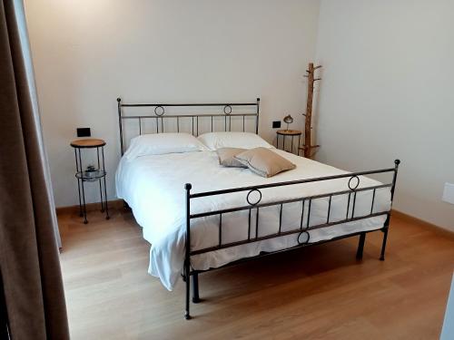 a bed with white sheets and pillows in a bedroom at SANTINO'S HOUSE in Peveragno