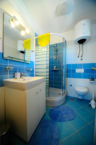 a bathroom with a sink and a shower and a toilet at Holiday home with pool, Supetar, Island Brac in Supetar