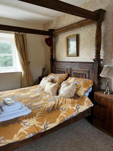 a bedroom with a large bed with a wooden frame at The nook 21a mill street in Kington