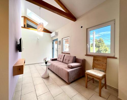 a living room with a couch and a window at Casa Histria Apartments in Šmarje