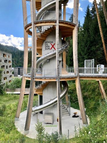 a tower with a clock on the side of it at Rancho Laaxdeluxe in Laax