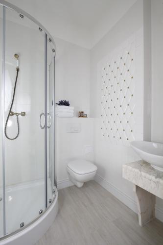 a bathroom with a shower and a toilet and a sink at Lawendowy Dworek in Lublin