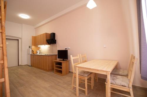 a kitchen and dining room with a table and chairs at Apartmány Pod Kolonádou in Janske Lazne