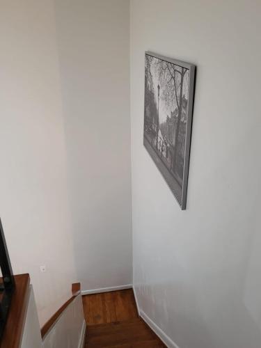 a picture hanging on a wall next to a staircase at Reservoir Hill Mansion - 4 bedrooms in Baltimore